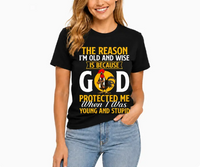 God Protected Me Graphic Tee – Christian Faith Humor Shirt, Old And Wise Quote T-Shirt, Black Cotton Blend Religious Top